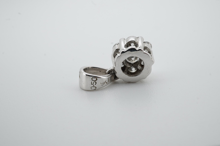 A diamond cluster pendant, set with brilliant-cut diamonds totalling approximately 0.50 carats, mounted in 9ct white gold, length 1.5cm, British hallmarks, Condition: good